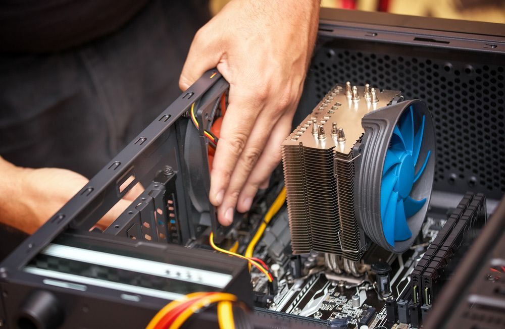 Computer Technician Installs Cooling System — PRO Solar & Electrical In Maitland, NSW