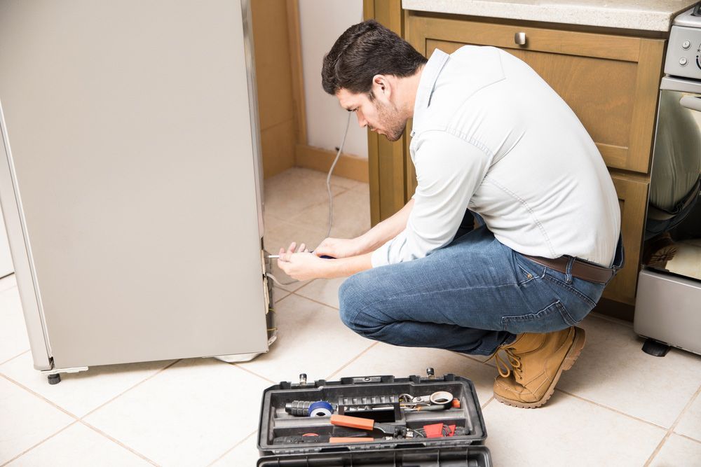 Electrician Fixing A Refrigerator — PRO Solar & Electrical In Maitland, NSW
