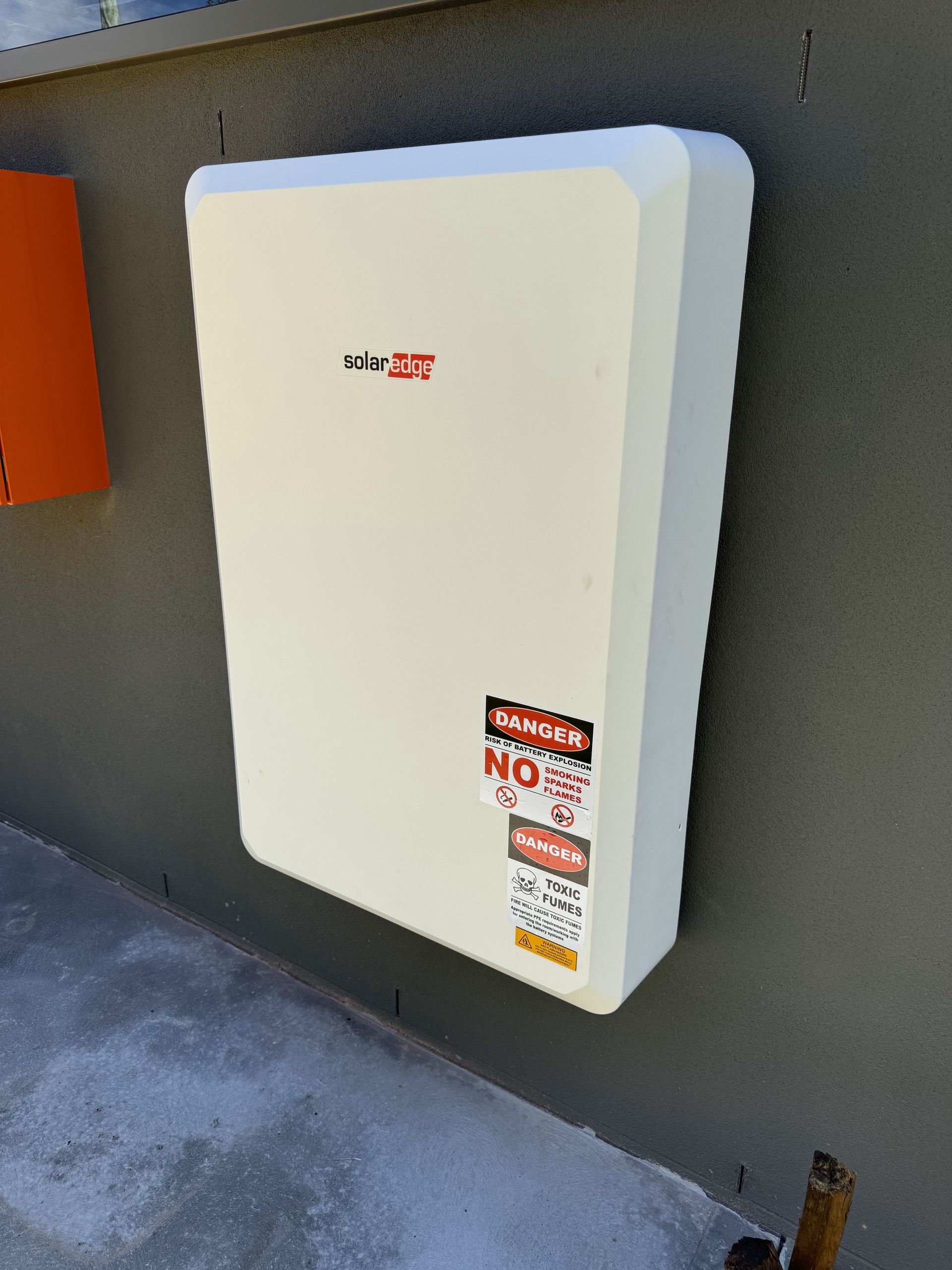 A battery Installed on The Side Of The House— PRO Solar & Electrical In Lake Macquarie, NSW