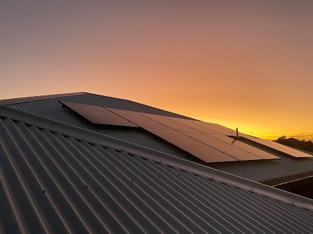 Solar Panels On A Rooftop With A Stunning Sunset Backdrop — PRO Solar & Electrical In Port Stephens, NSW