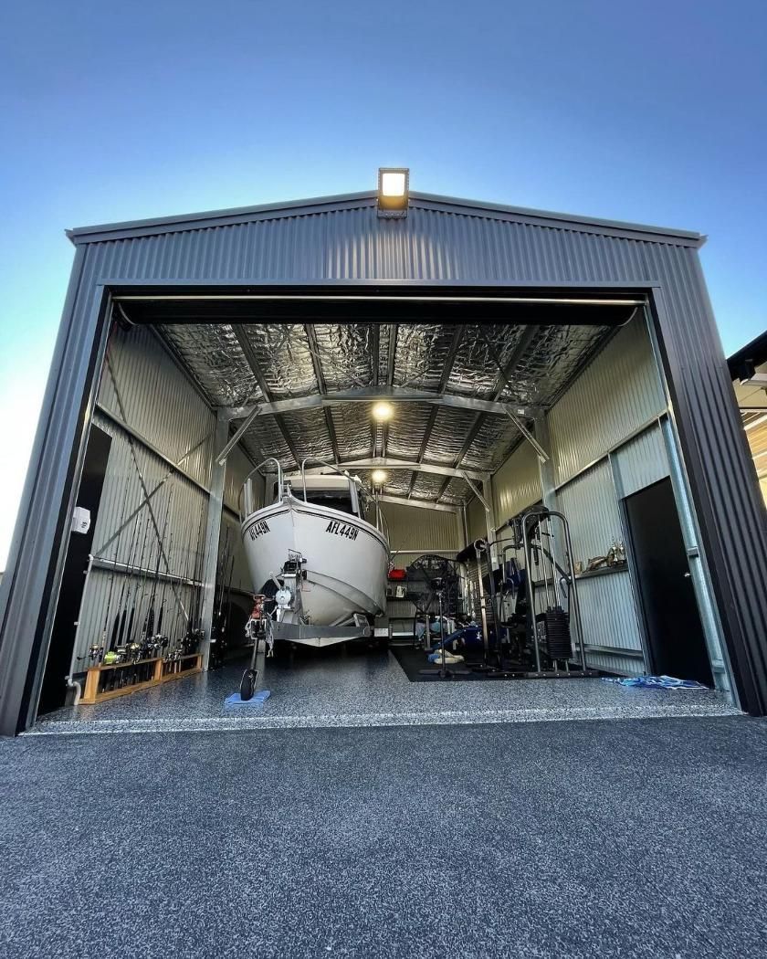 Big Black Shed With Boat Inside — PRO Solar & Electrical In Newcastle, NSW