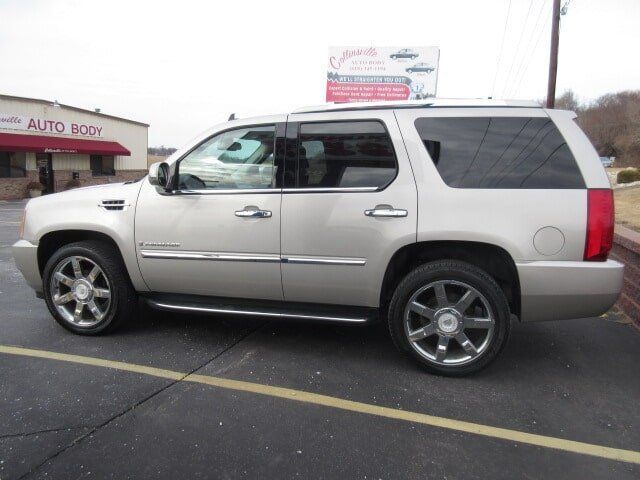 Silver SUV parked in a lot outside an auto body shop
