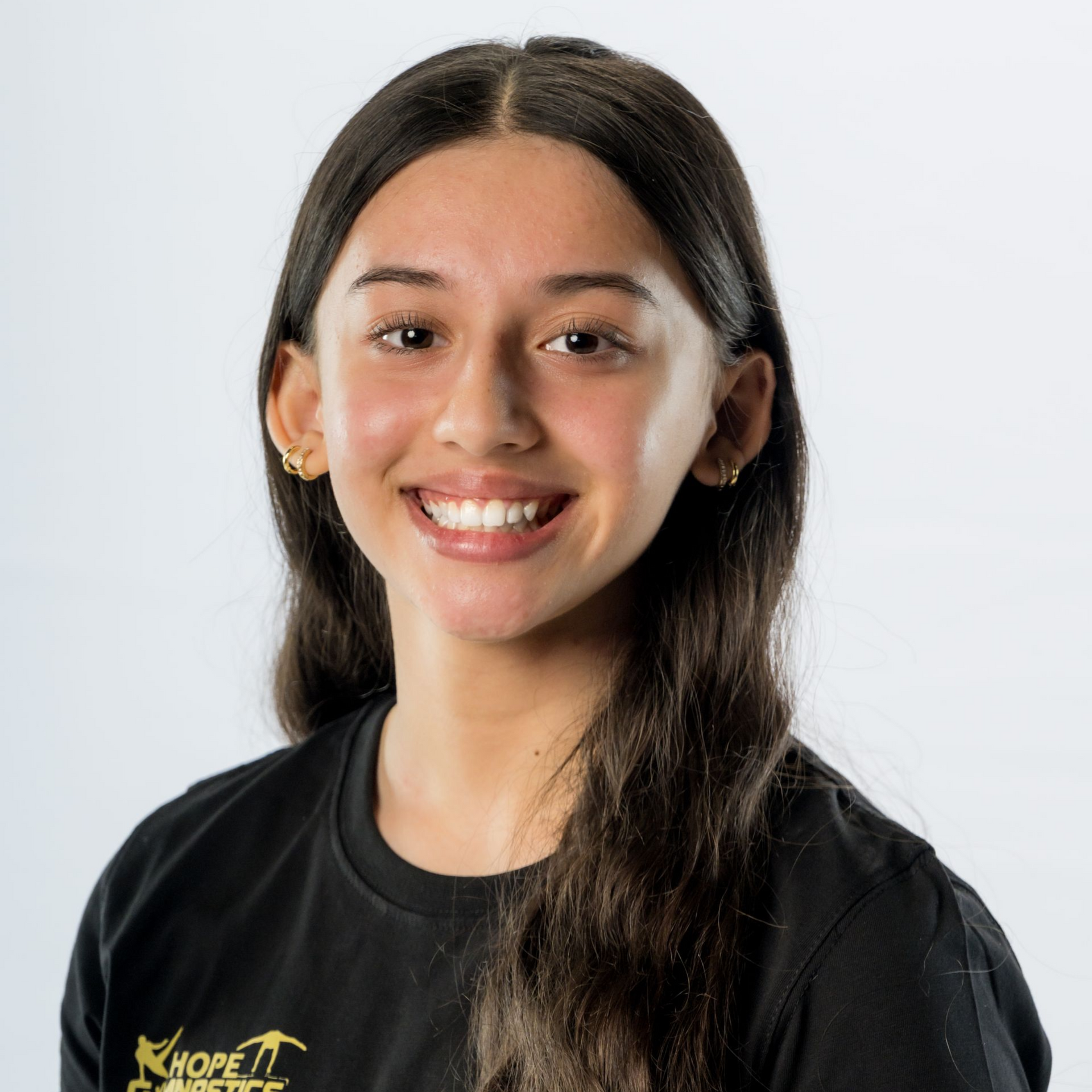 Portrait of a smiling person in a black T-shirt against a light background