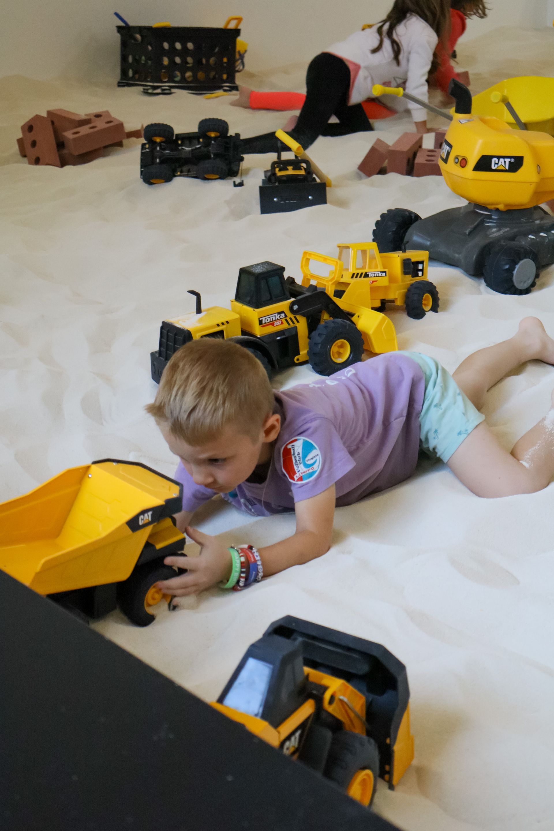 Kids playing in the indoor sand playground