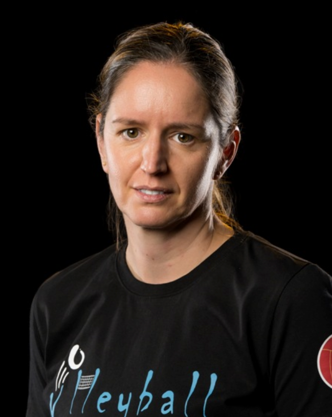 Portrait of a volleyball player in a black jersey against a dark background