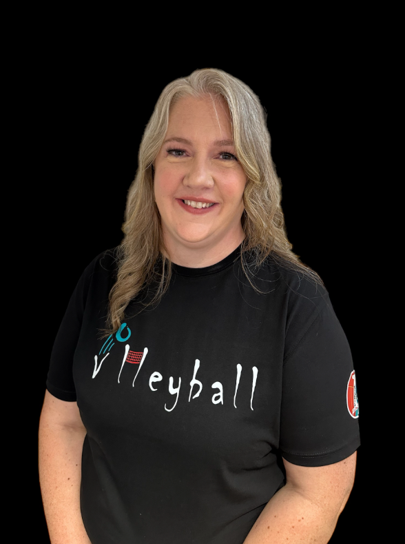 Smiling woman in black volleyball T-shirt against a black background