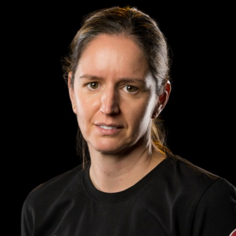 Close-up portrait of a person in a black shirt against a black background