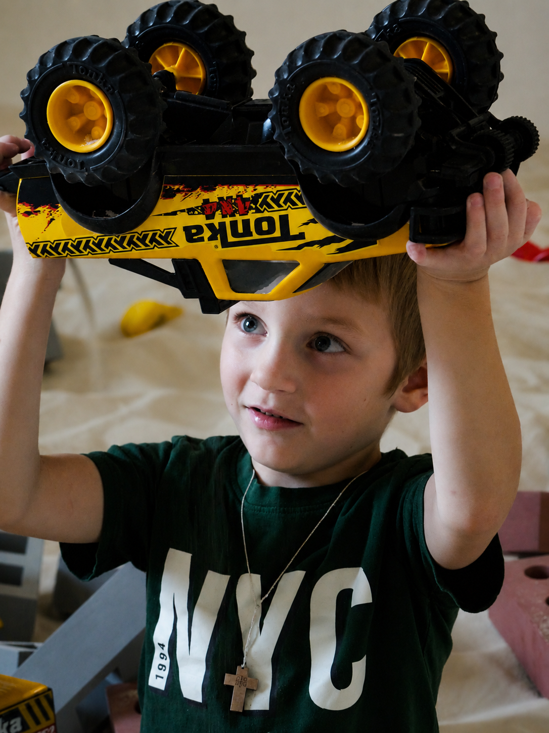 Child playing with a toy dump truck in the Little Sandy Feet indoor sand playground