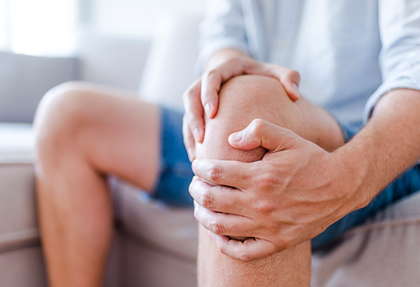 Man Massaging His Painful Knee — New Bedford, MA — Fairhaven Chiropractic Office