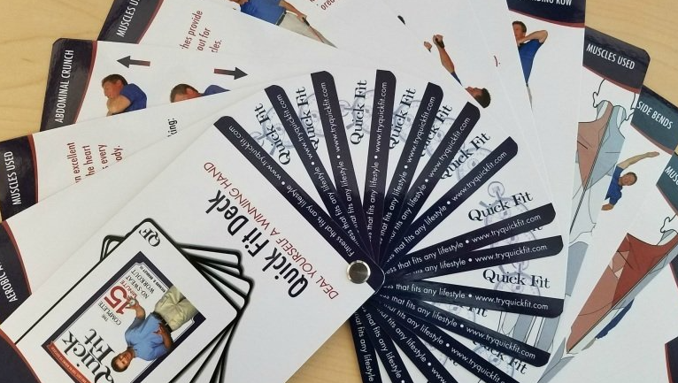 A bunch of exercise cards are stacked on top of each other