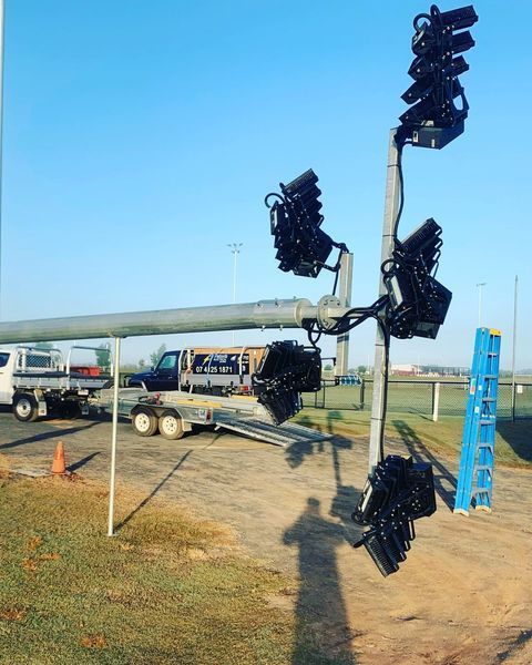A Bunch of Lights Are Sitting on Top of A Pole — Paton's Electrical Services in Urraween, QLD