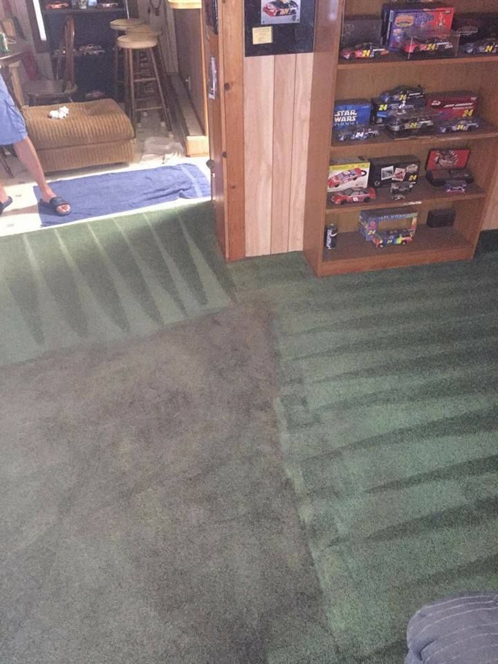 A carpeted room with green shag carpet, showing a dark, rectangular patch of deep cleaning contrasted with clean lines.