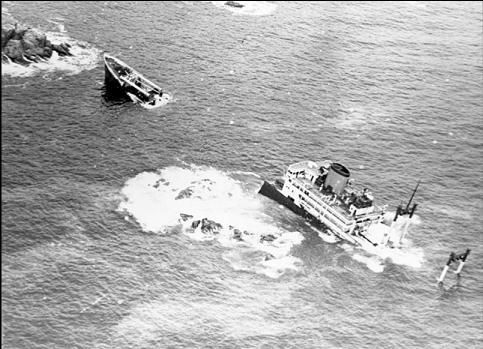 A black and white photo of two boats in the ocean near Woods End Landing in Bamfield BC