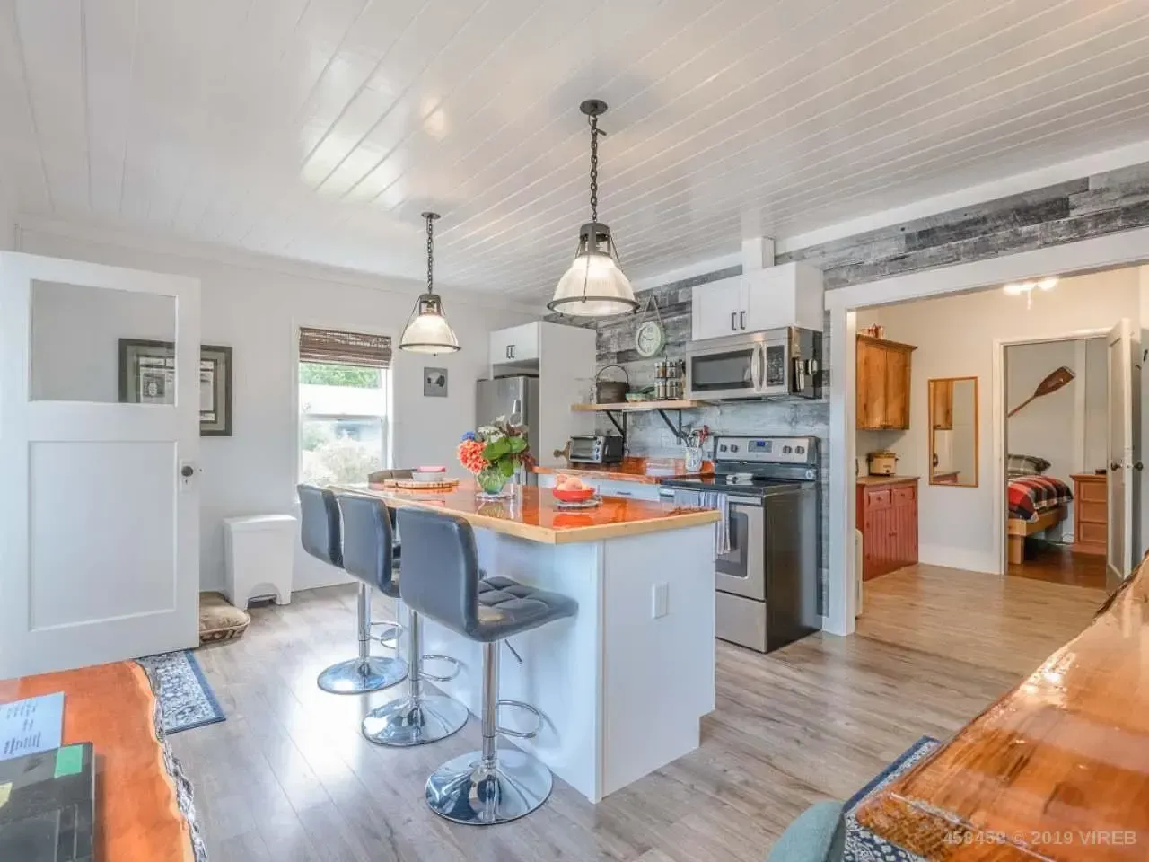 A kitchen with a large island and stools