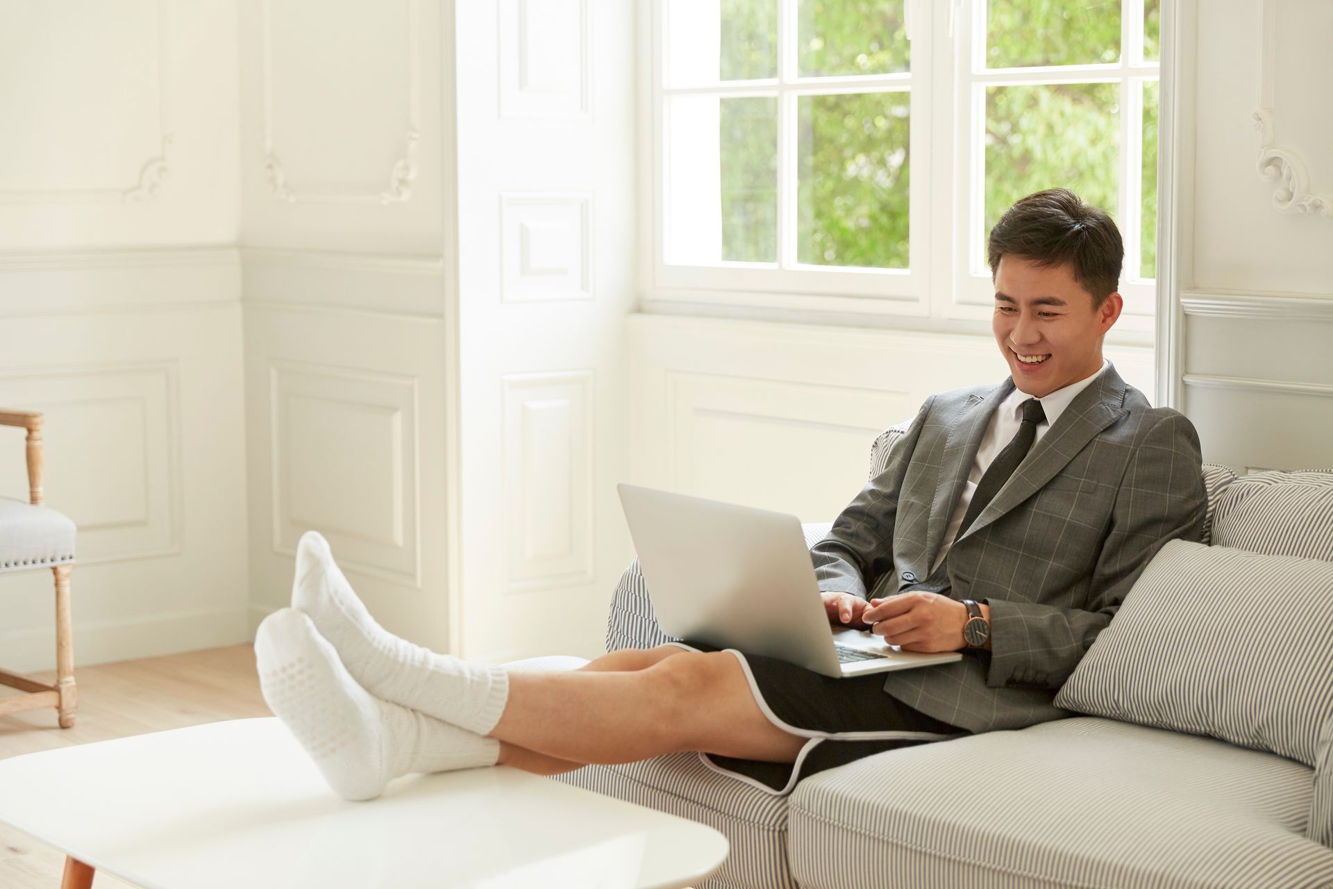 Fellow on sofa working from home