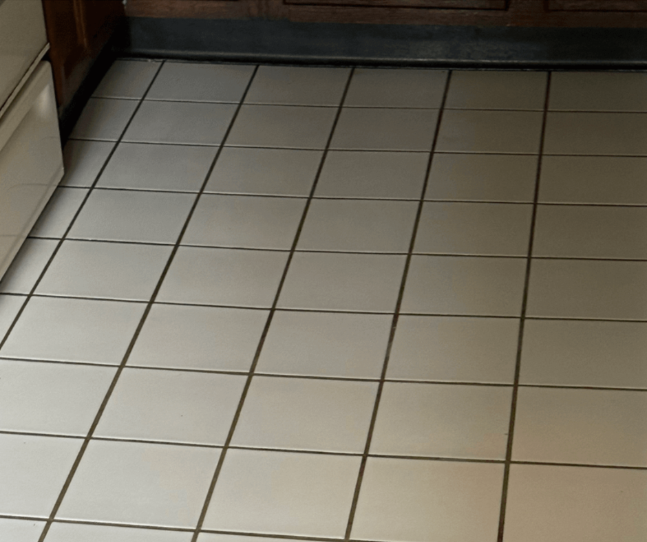 White tiled kitchen floor with dark grout, viewed from above