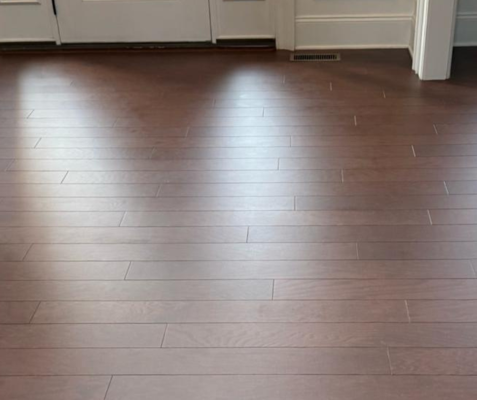 Empty kitchen with dark wood floor and white cabinets