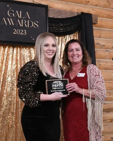 Two women are standing next to each other in front of a sign that says gala awards 2023.