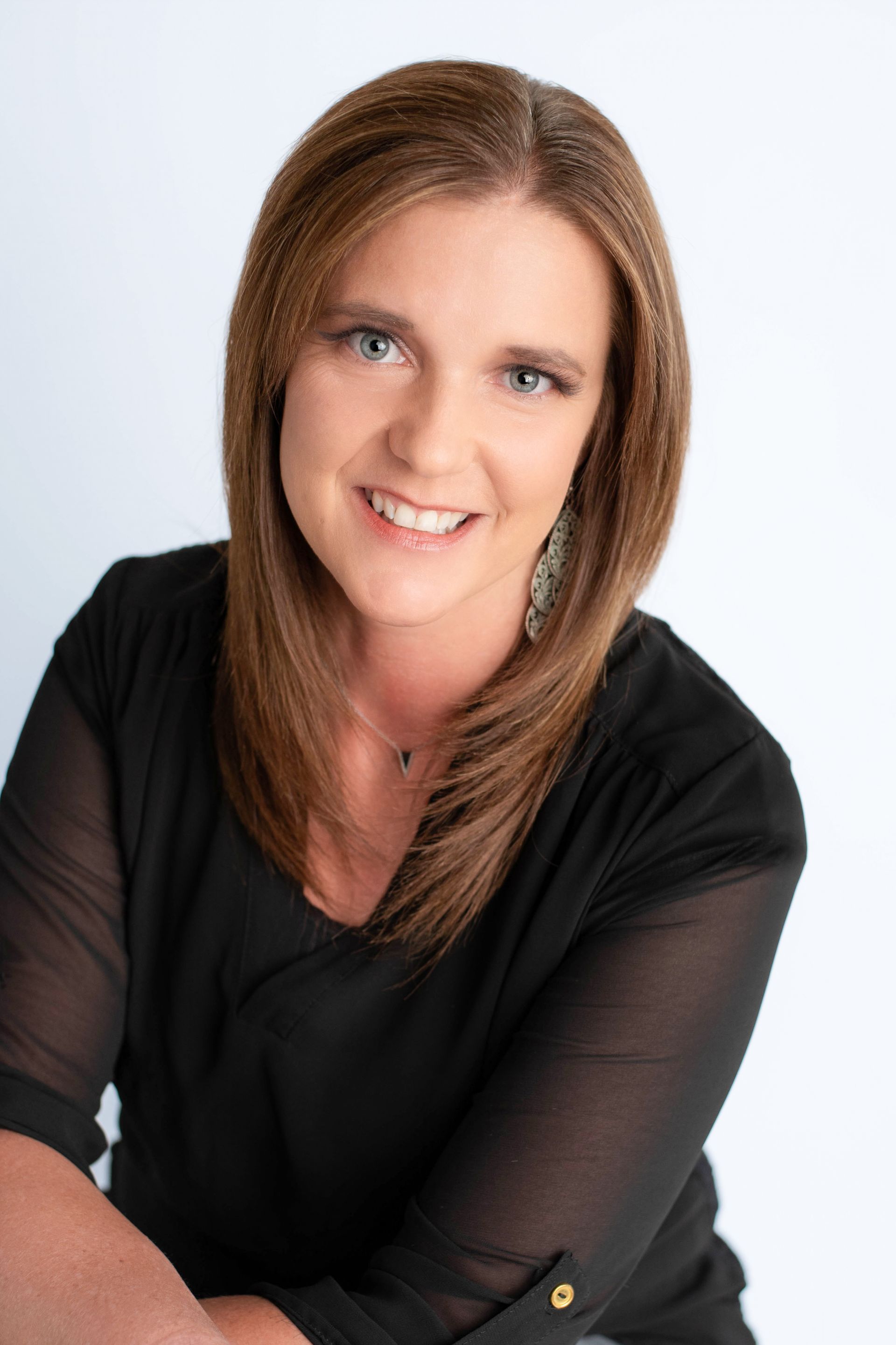 A close up of a woman 's face smiling.