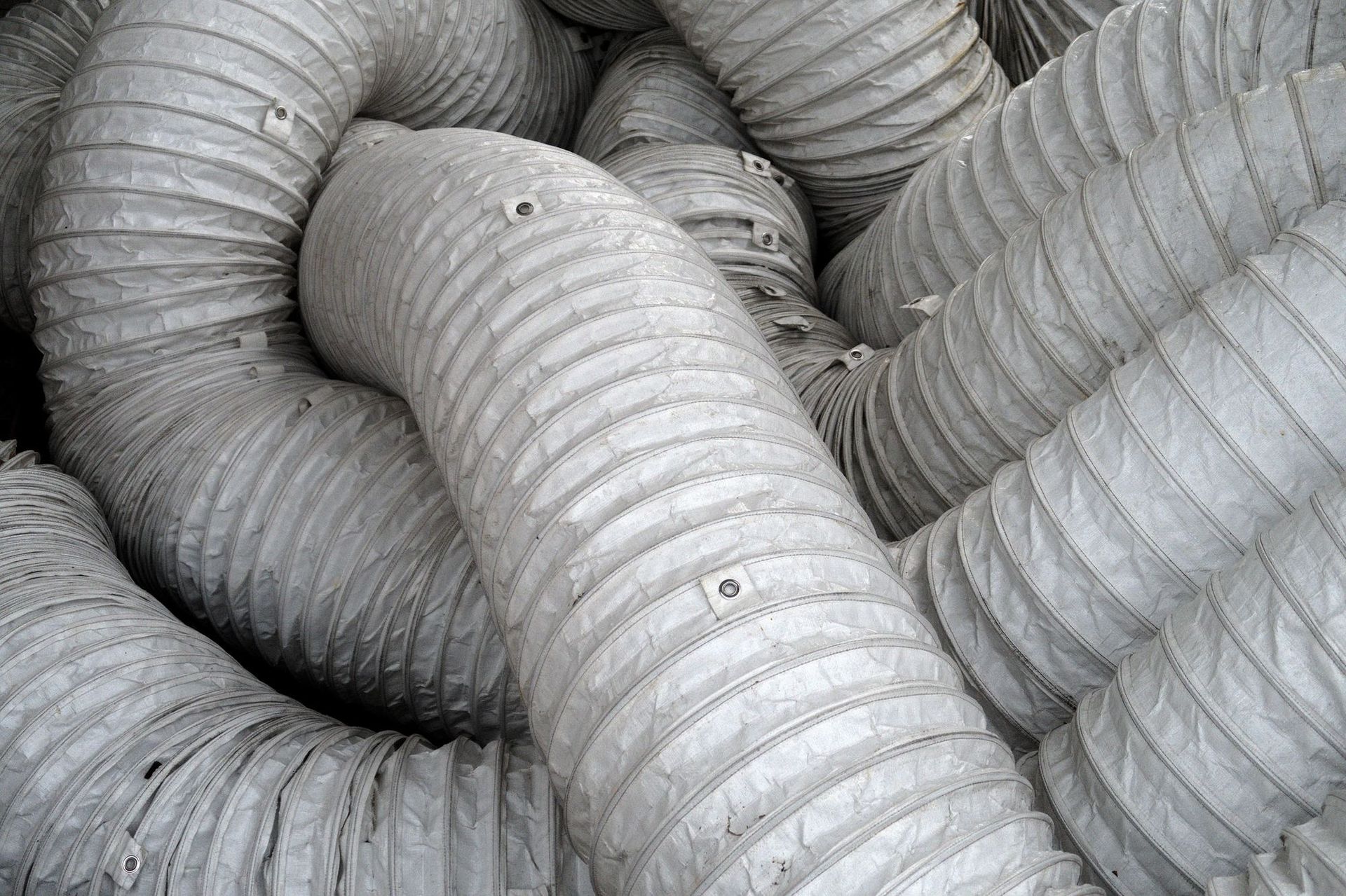 A bunch of white ducts are stacked on top of each other.