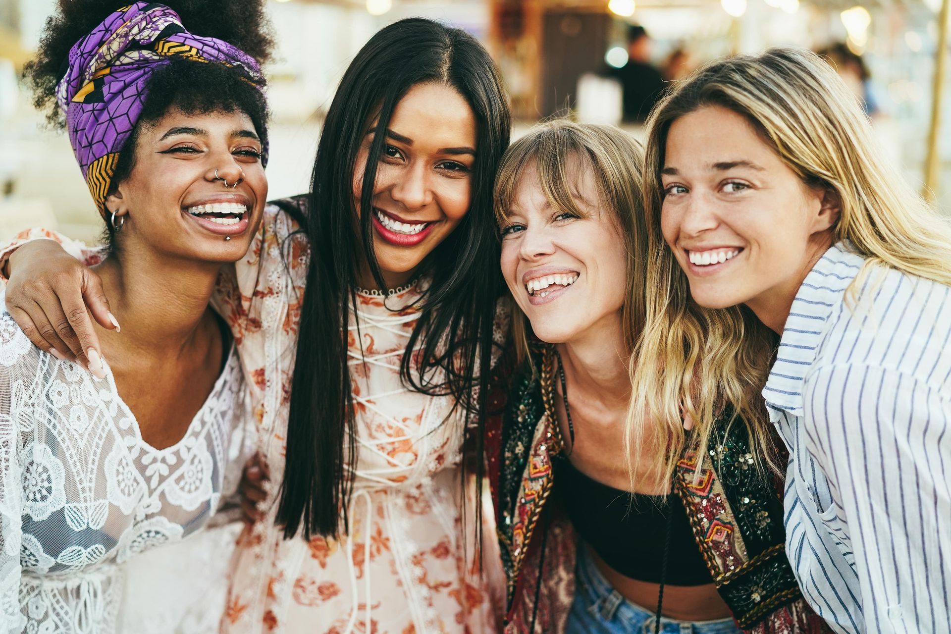 A group of women are posing for a picture together and smiling.
