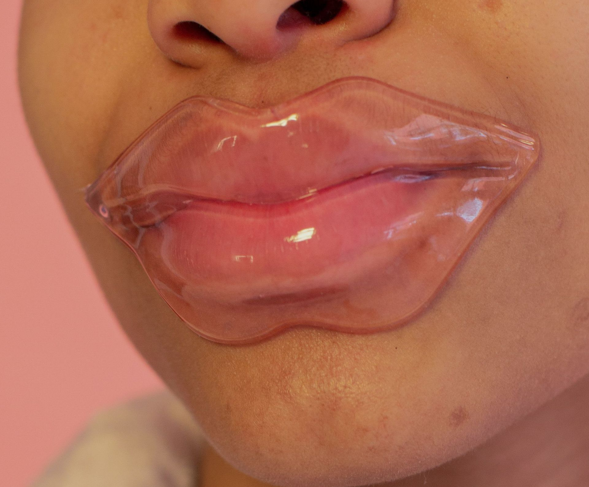Close-up of lips with glossy clear transparent lip art on the mouth