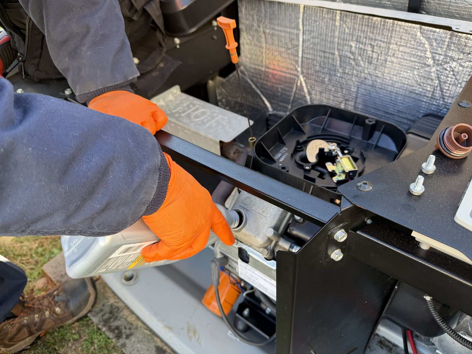Generac whole-house generator with black control panel, white exterior, and orange logo