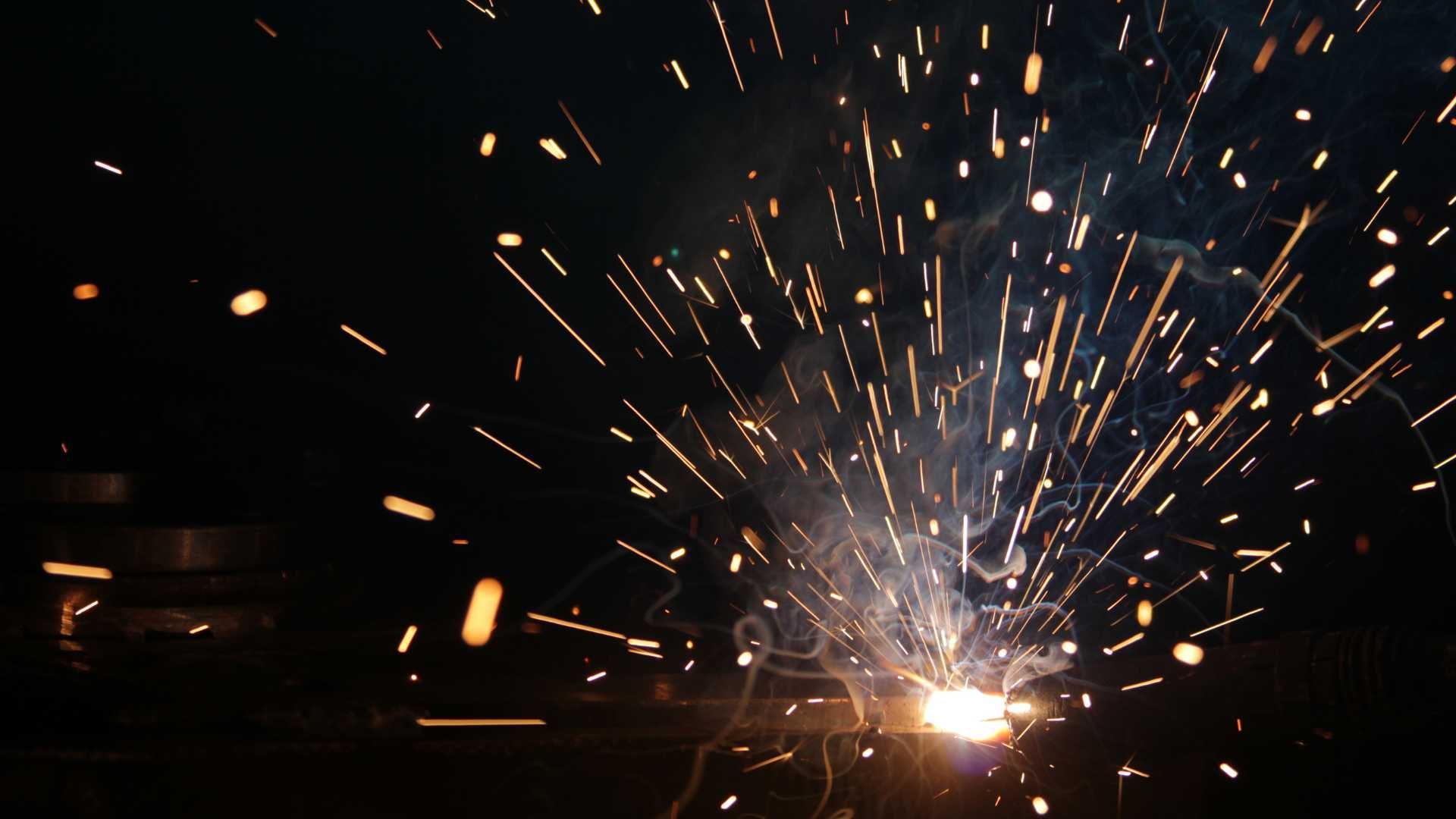 A fireworks display in the dark with sparks flying in the air