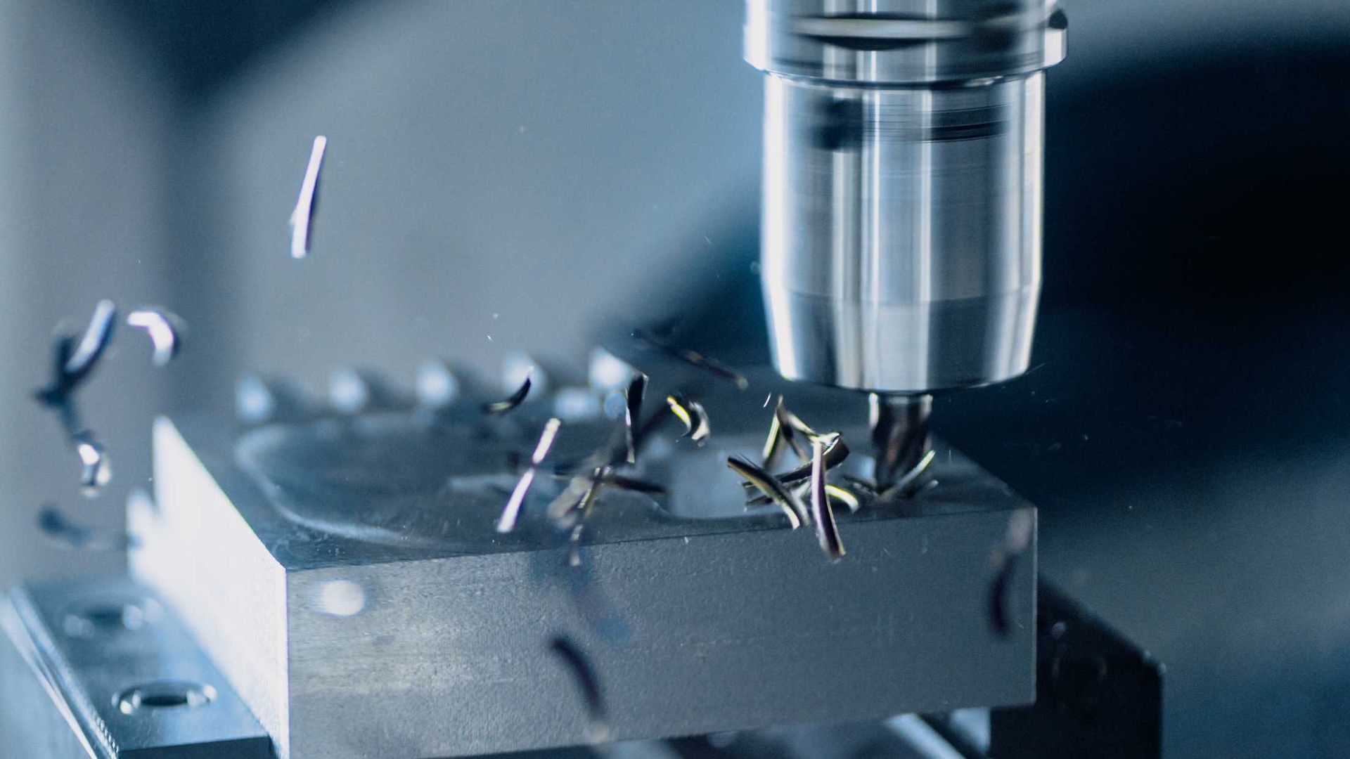 A machine is cutting a piece of metal on a table.