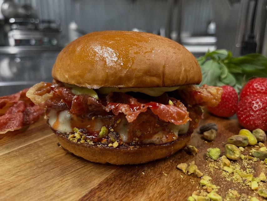 Cheeseburger with lettuce, tomato and fries on a tray in a restaurant