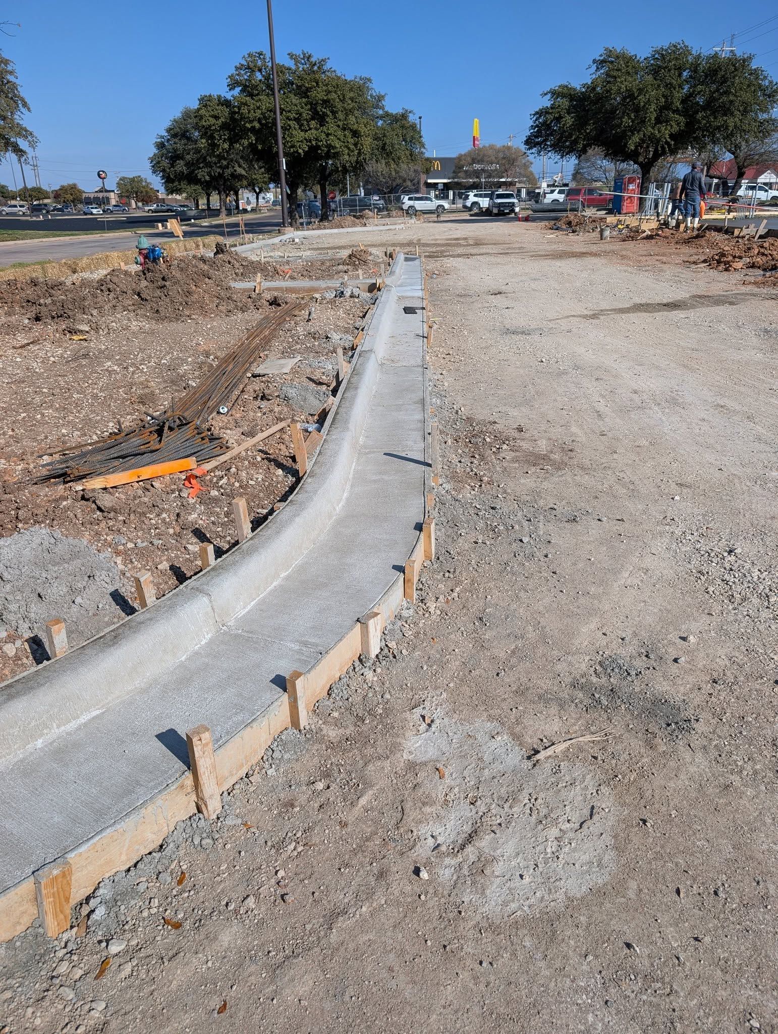 New concrete curb being built with wooden formwork.