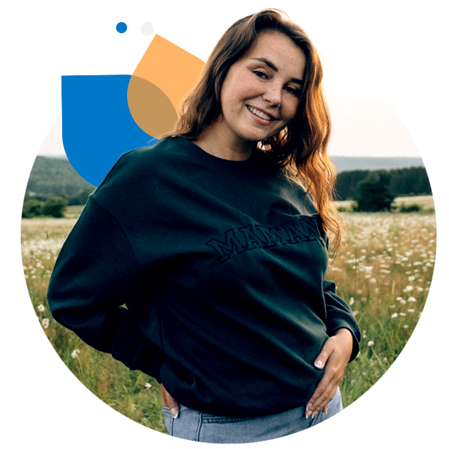 Audrey, standing in a rural field on an Autumn day.