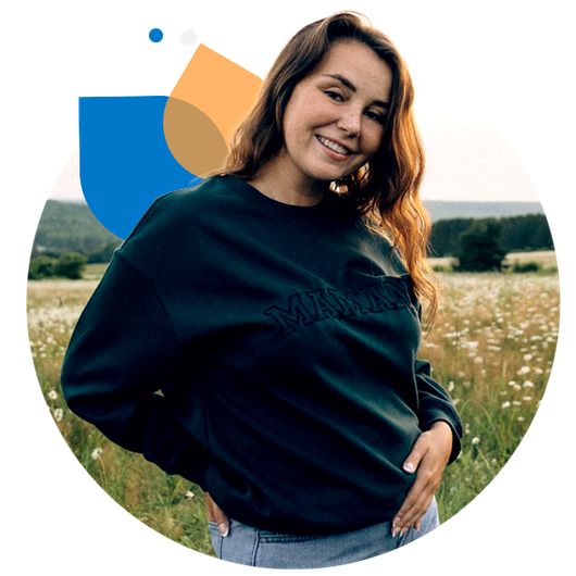 Audrey, standing in a rural field on an Autumn day.