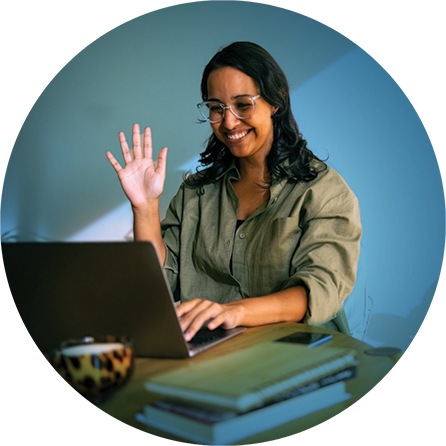 A young woman sitting at her laptop in a virtual meeting