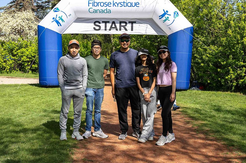 A group of five walkers in front of the starting line at The Walk to Make Cystic Fibrosis History.