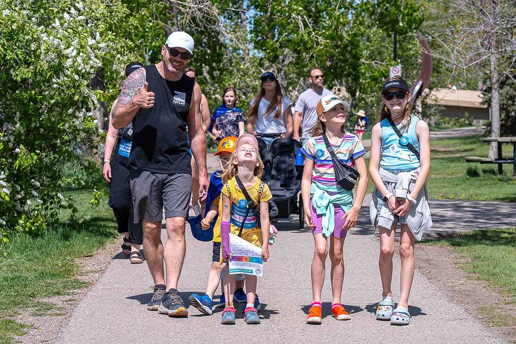 A father and his three daughters stroll outside along the Walk route at The Walk to Make Cystic Fibrosis History.