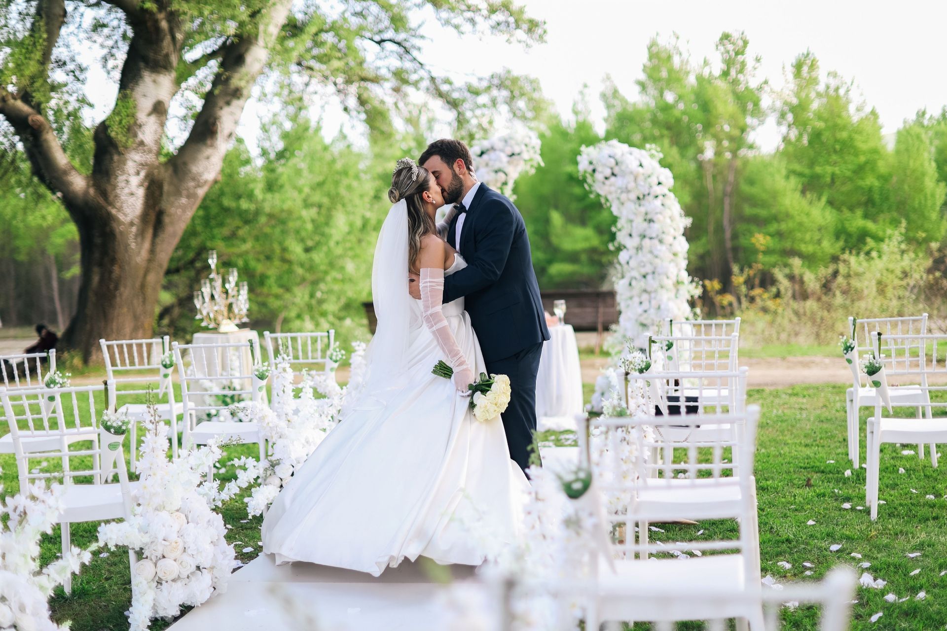 bride and groom kissing at the outdoor wedding venue in Marion, IN, The Covenant Place.