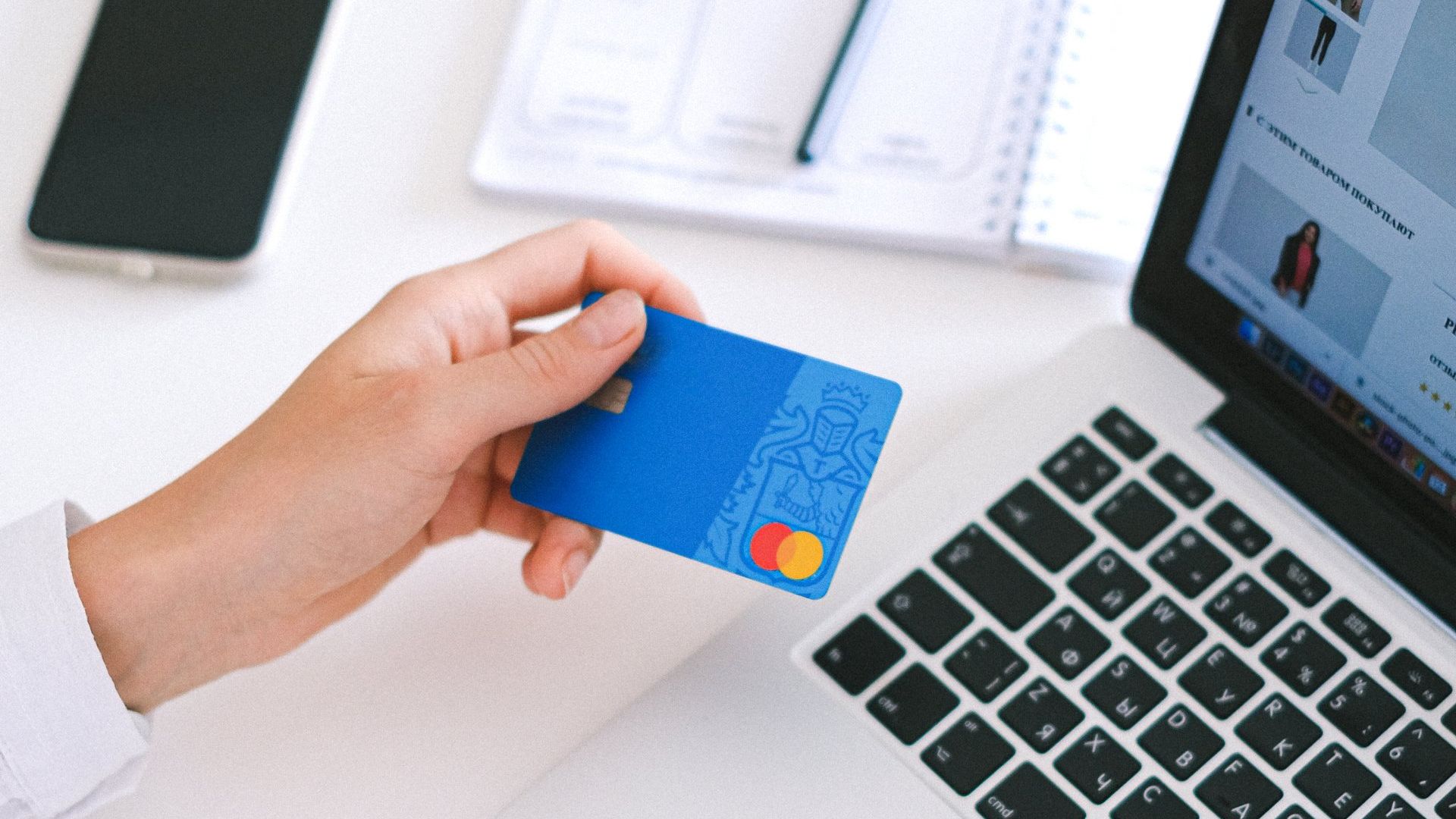 Credit card with laptop and mobile phone