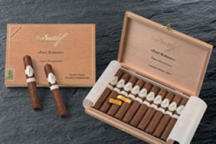 Two open cigar boxes with cigars displayed on a dark surface
