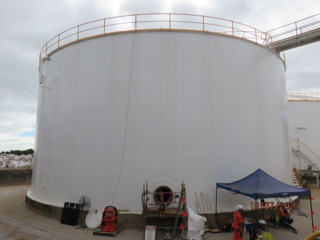 A Large White Tank With A Blue Tent In Front Of It — LJ's Technical Services In Burdell, QLD