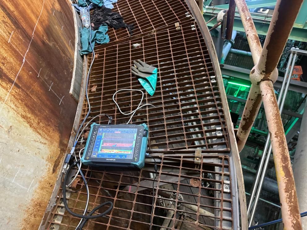 A Tablet Is Sitting On Top Of A Metal Grate — LJ's Technical Services In Burdell, QLD