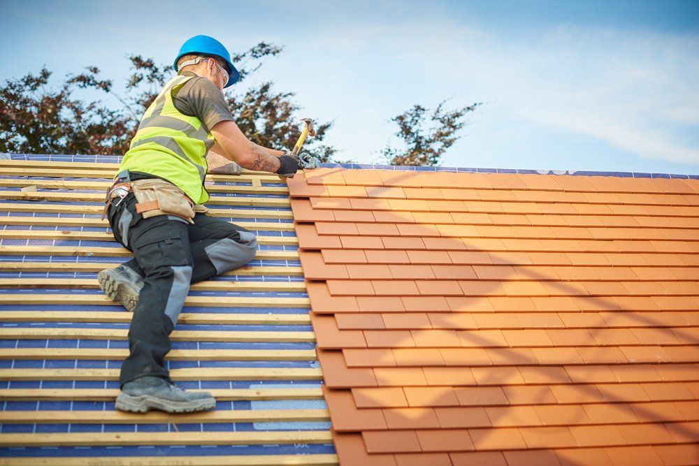 Installing New Roof Shingles — Carlsbad, NM — ENM Construction Management Ltd Installing New Roof Shingles — Carlsbad, NM — ENM Construction Management Ltd