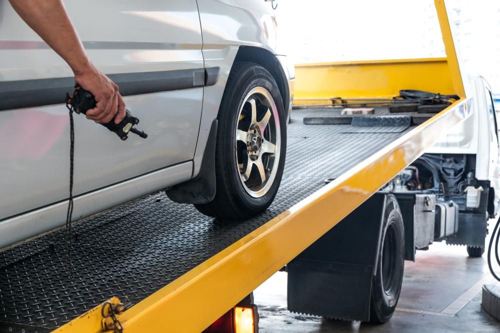 A Car is Being Towed by a Tow Truck — DJ's Tilt Tray Service in Sawtell, NSW