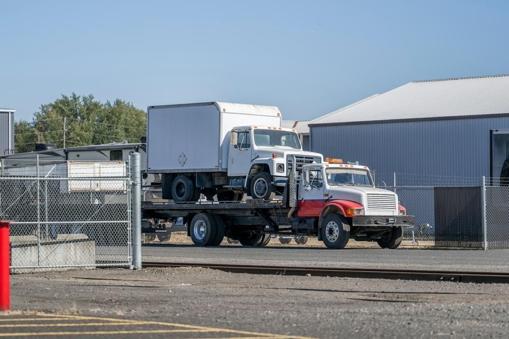 Two Trucks Are Parked in a Parking Lot Next to Each Other — DJ's Tilt Tray Service in Coffs Harbour, NSW