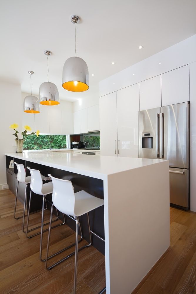 A Kitchen With White Cabinets And Stainless Steel Appliances — O'Donnell Cabinetmaking in Emu Park, QLD