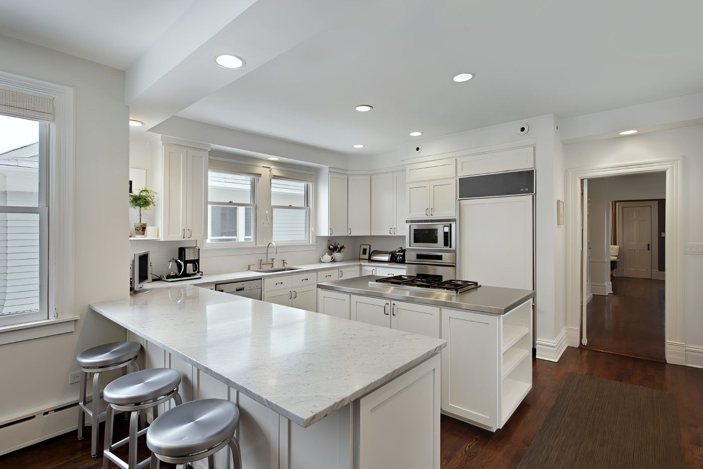 A Kitchen With White Cabinets And Granite Counter Tops — O'Donnell Cabinetmaking in Kawana, QLD