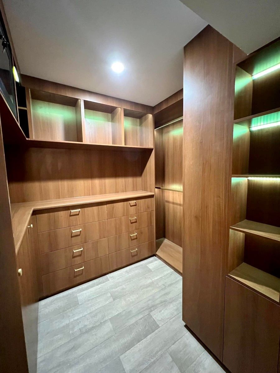 A Walk In Closet With Wooden Cabinets And Shelves — O'Donnell Cabinetmaking in Kawana, QLD