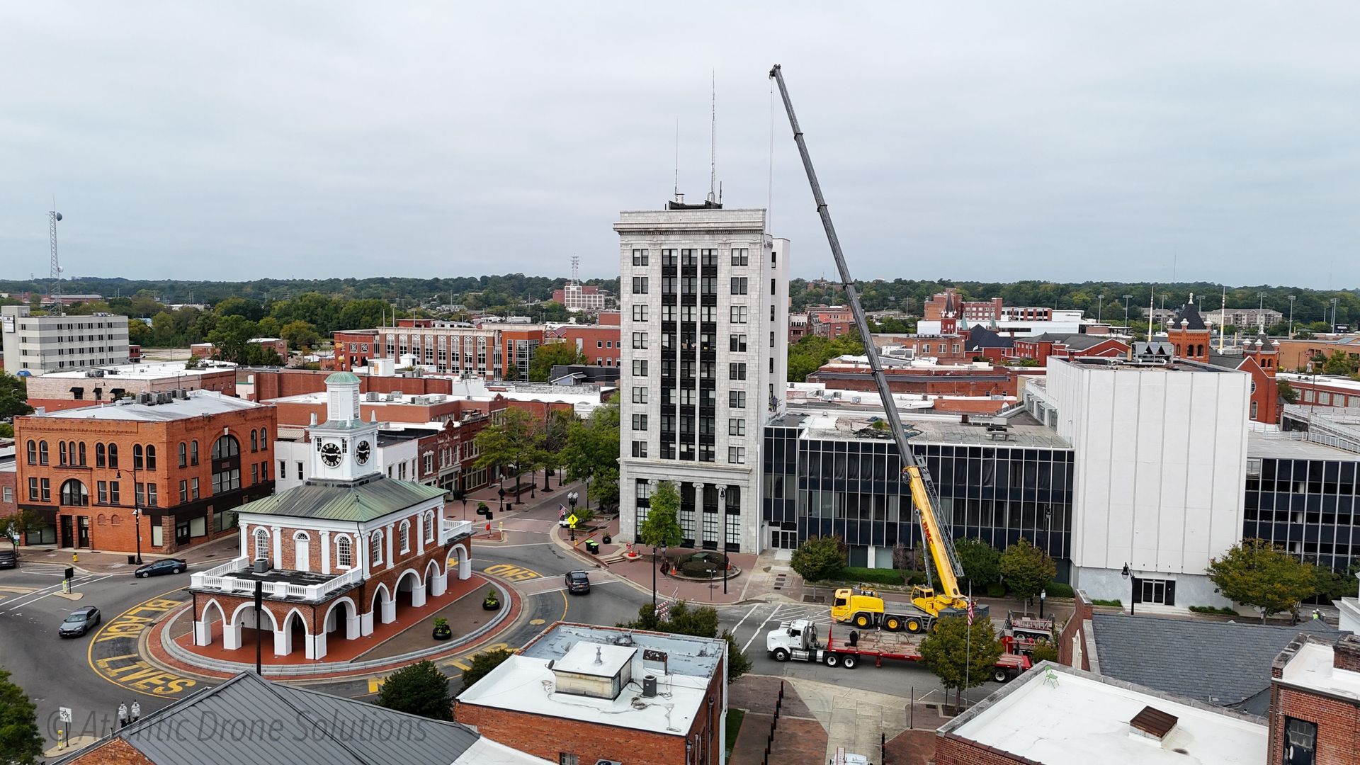 An aerial view of a city with a crane in the foreground. — Fayetteville, NC — Bill's Mobile Crane Service