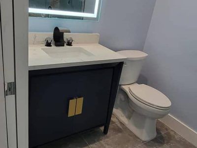 A bathroom with a sink , toilet and mirror.