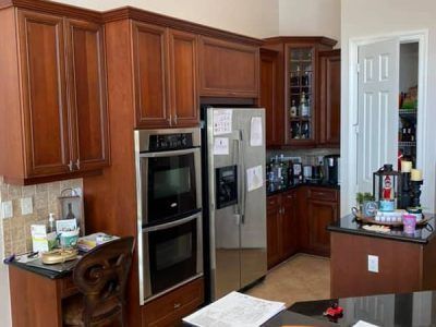 A kitchen with stainless steel appliances and wooden cabinets.
